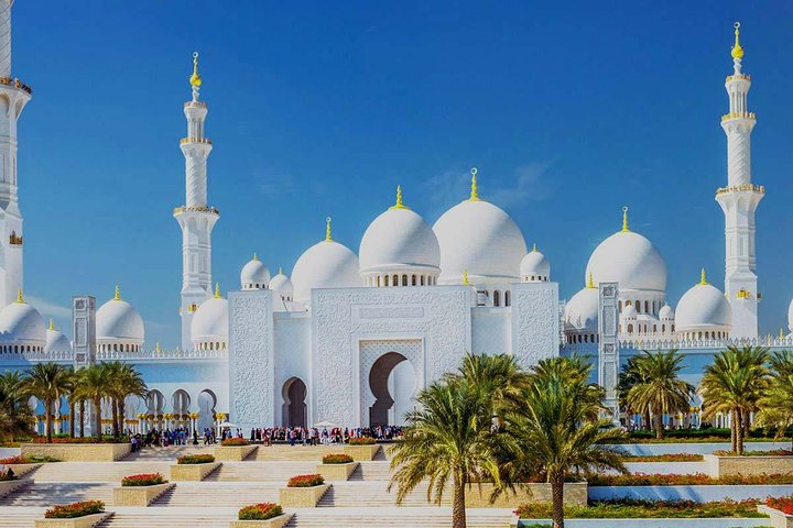 Explore the stunning architecture of Sheikh Zayed Grand Mosque an iconic symbol of Abu Dhabi's rich cultural heritage surrounded by serene gardens and majestic palm trees.